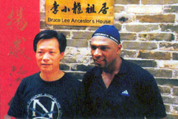 Garry with Sifu Ha Ji Sing outide Bruce Lee's ancestors house in Seun Dak, Southern China.